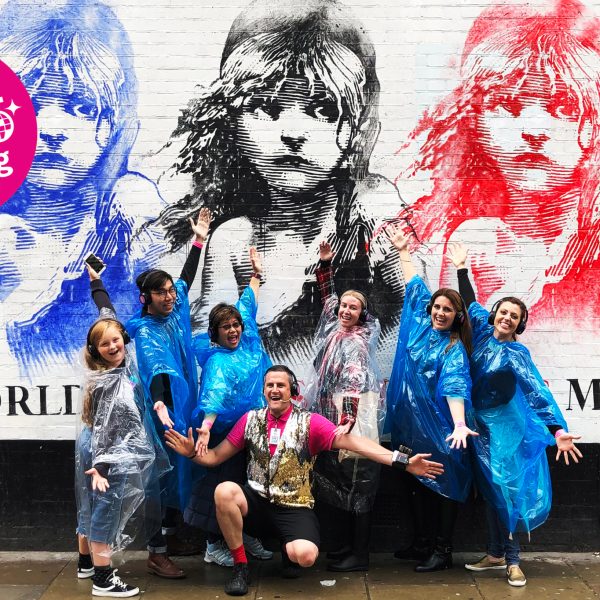 people posing in front of a wall